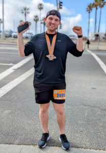 Man celebrating after running a half marathon